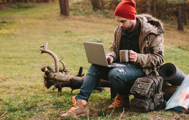 Young blogger photographer travel in mountain forest