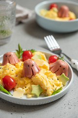Octopus sausage with scrambled eggs served for kid breakfast