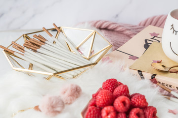 Naklejka premium Cup of freshly brewed fruit and herbal tea, fresh raspberry, cookies, book, clothes. Photo for fashion, lifestyle and food blogs, content