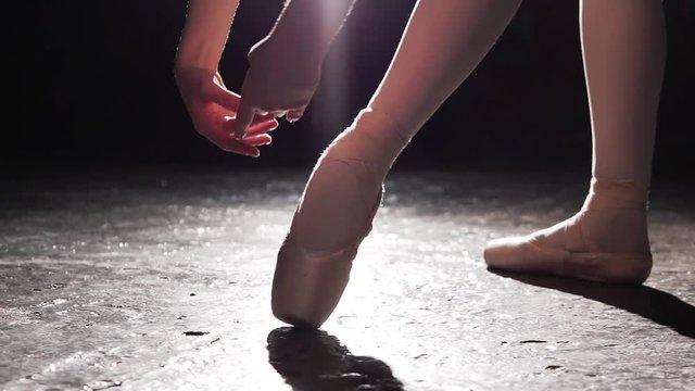 Beautiful legs of young ballerina in pointe shoes. Ballet practice. Beautiful slim graceful legs of ballet dancer.