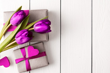 gift boxes with flowers on white wooden background