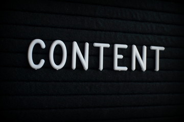 The word Content in white plastic letters on a black letter board 