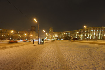 Fototapeta na wymiar Snowy walking in winter Moscow. Blizzard time. Leninsky prospect at the winter night.