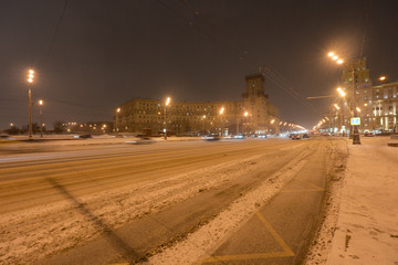 Snowy walking in winter Moscow. Blizzard time. Leninsky prospect at the winter night.