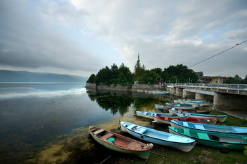 Fototapeta na wymiar Boats on lake are tied under a bridge in Golyazi village, Bursa / Turkey