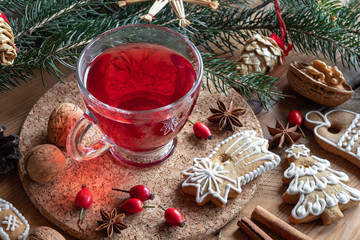A cup of rose hip tea with Christmas gingerbread cookies