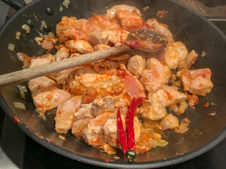 fried chicken with vegetables in the frying pan