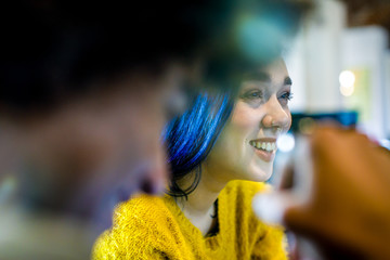 Modern blue hair woman smiling.Group of multiethnic people having business team meeting in restaurant lounge.Teamwork,corporate,diversity and social concepts.