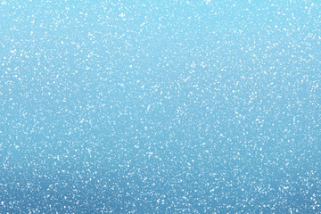 Snow falls on winter blue sky background