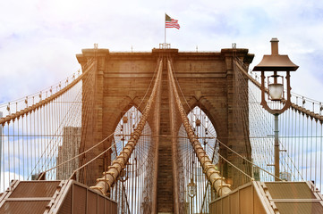 Brooklyn bridge with united states flag on top