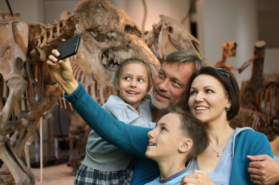 Portrait of happy family taking selfie with smartphone