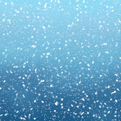 Fototapeta na wymiar Snow falls on winter blue sky background