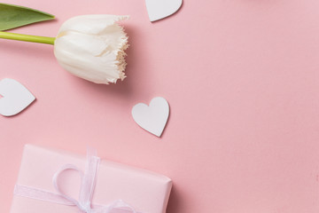 Pink celebration background, flowers, hearts and gift.