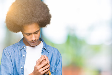 Young african american man with afro hair Suffering pain on hands and fingers, arthritis...