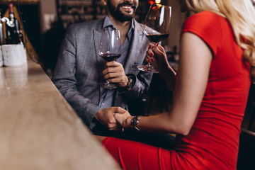 Romantic date in restaurant, young couple at bar counter.