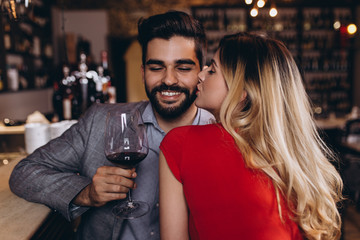 Romantic date in restaurant, young couple at bar counter.