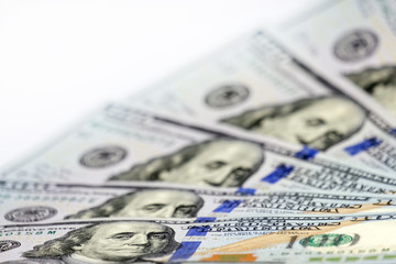 Shallow depth of field, small DOF, selective focus. New one hundred US dollar bills are like a fan. Blurred. Financial or business background for the designer.