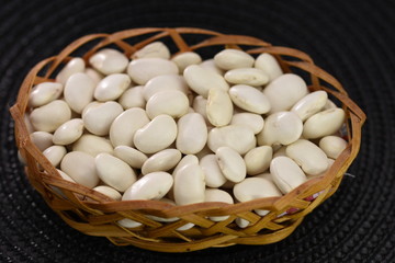 white beans  in a wicker basket