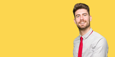 Young handsome business man Inviting to enter smiling natural with open hand