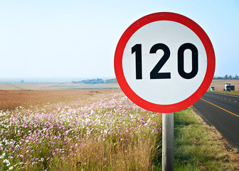 A speed sign of 120 Kilometer per hour, next to a road, overlooking a valley, in kwazulu natal,...
