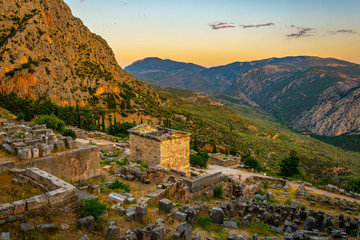 Sunset view of Athenian treasury at the ancient delphi site in Greece