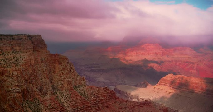 Grand Canyon National Park vista during daytime with blue skies and wispy clouds.  4K DCI. Camera pans right.