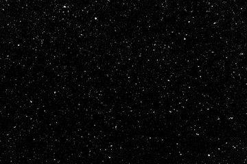 Real snow falling in a winter night. White snow on black background. Abstract elements to use in...