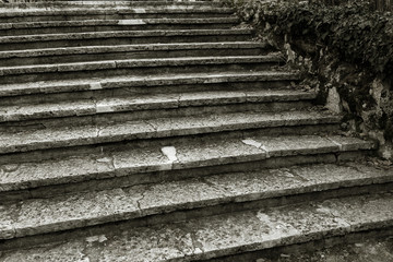 An old open outer stone staircase. Stone, cement steps of the old staircase with traces of...