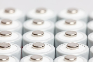 AA batteries are close to each other. Close-up of white batteries on a white background. Battery...