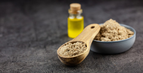 Minced seeds of a milk thistle (Silybum marianum) and oil on dark background