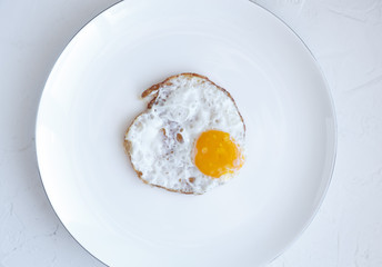 Fried egg isolated on white background, top view