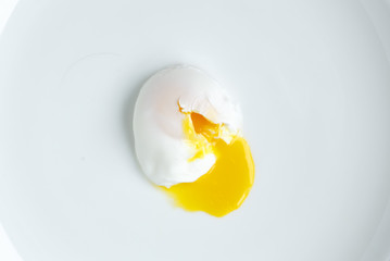 poached egg closeup shot on white background - obrazy, fototapety, plakaty