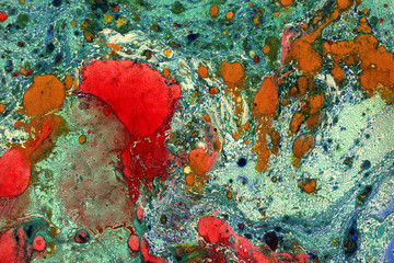 Gorgeous textured images of old marbled paper. Abstract grunge vintage background with genuine original marbleized effect. Red and green colors.