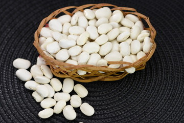 white beans  in a wicker basket