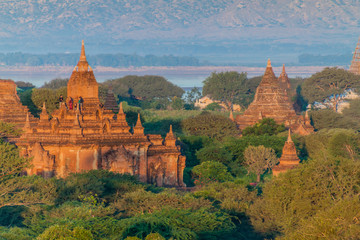 BAGAN, MYANMAR - DECEMBER 8, 2016: Tourists observe sunrise from a temple in Bagan, Myanmar
