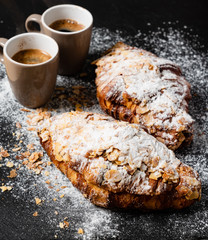Croissants with almonds on the black background