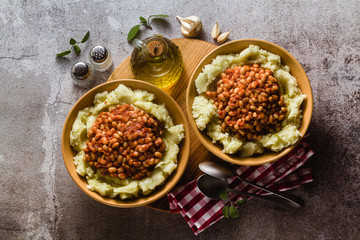 mashed potatoes with stewed white beans in tomatoes. winter warming recipe from vegan cuisine