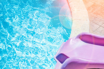 Stylishly interesting water slide in the pool near the sea on nature background