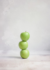 Three apples stacked on top of each other
