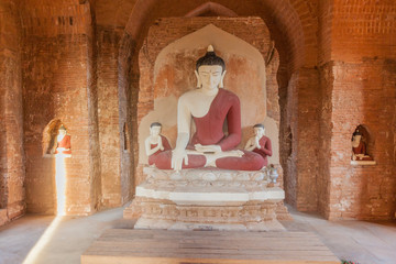 Sun beam reaching a Buddha statue in a small temple in Bagan, Myanmar