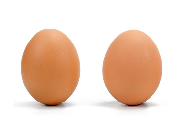two brown chicken eggs in a row against a white background.
