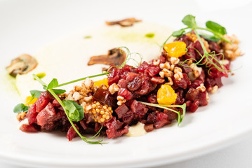 plate with delicious tartare and mushroom puree. Isolated on the white background