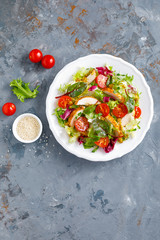 Fresh vegetable salad with grilled chicken meat, top view