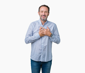 Handsome middle age elegant senior man over isolated background smiling with hands on chest with closed eyes and grateful gesture on face. Health concept.