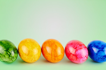 Colored Easter eggs on green background