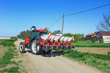 Fototapeta premium Tractor with seeder on the road