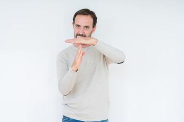 Elegant senior man over isolated background Doing time out gesture with hands, frustrated and...