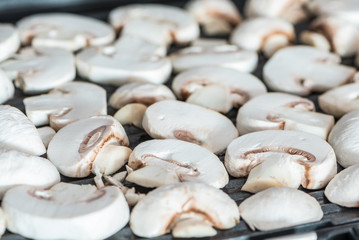Sliced champignons mushrooms grilled on electric grill or BBQ close up view