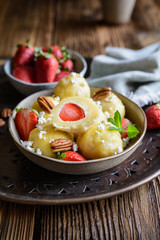 Sweet dumplings stuffed with strawberries topped with curd