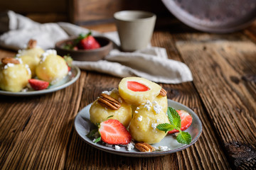 Sweet dumplings stuffed with strawberries topped with curd